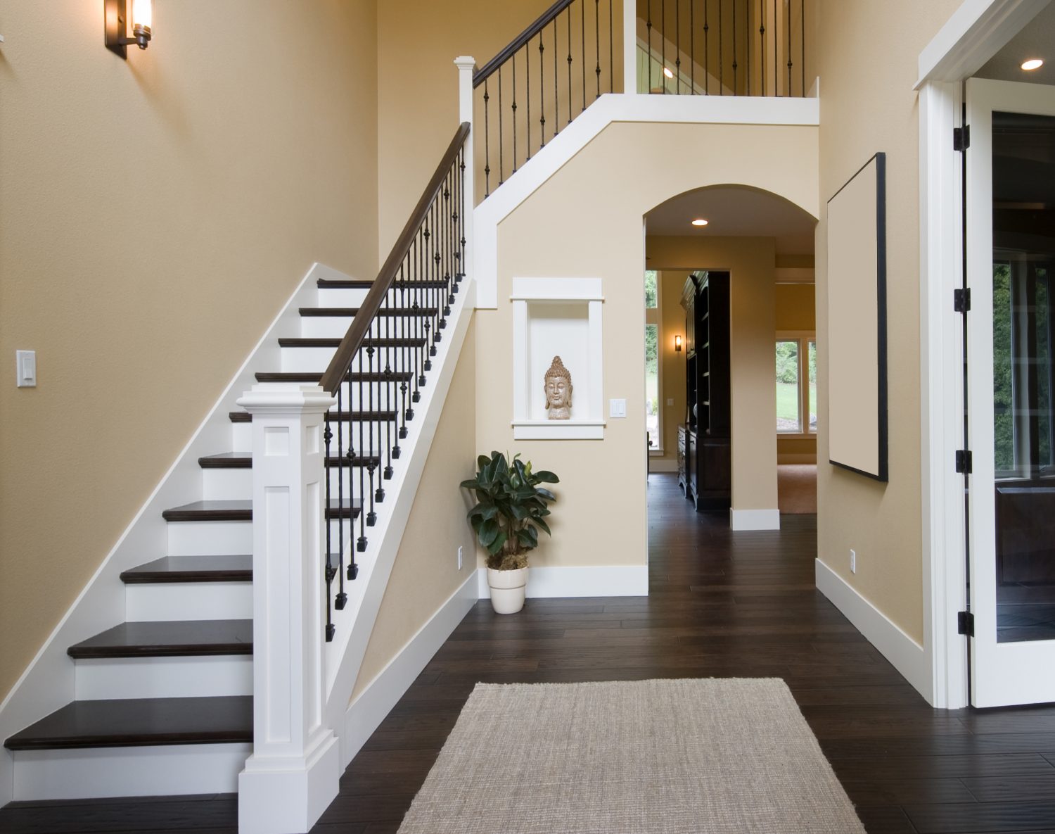 Finished two-story stairwell with warm neutral walls and white millwork in Suntree, FL