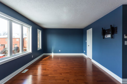Finished room painted deep navy blue with bright white baseboards and trim in Cocoa, FL