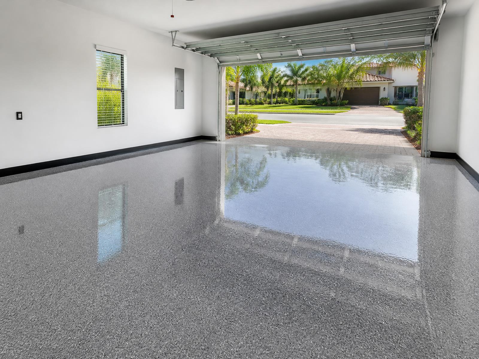 Newly coated Palm Bay, FL garage floor with a grey flake epoxy finish by Pro Touch Painting
