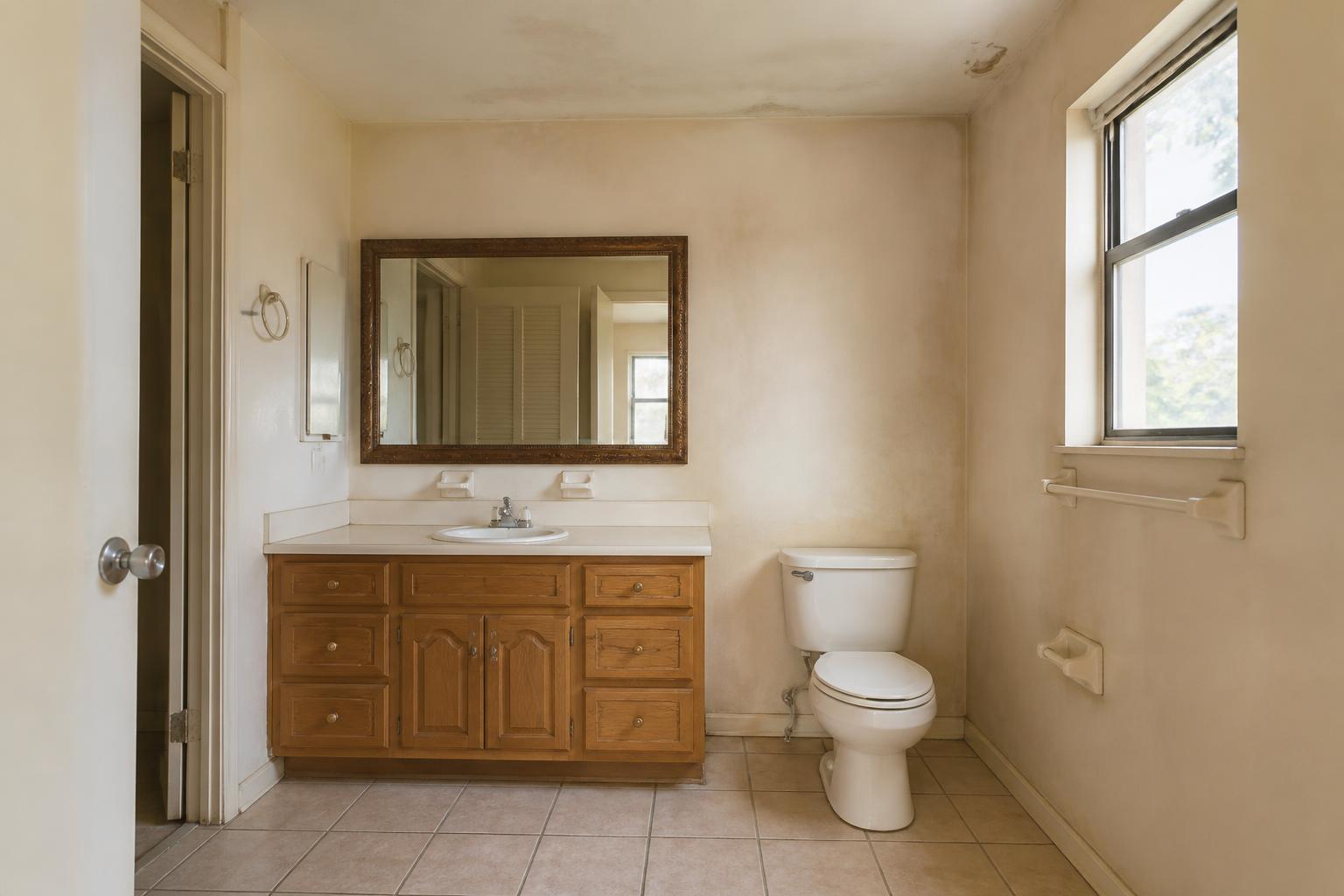 Bathroom with dated wall color before repainting in Cocoa Beach, FL
