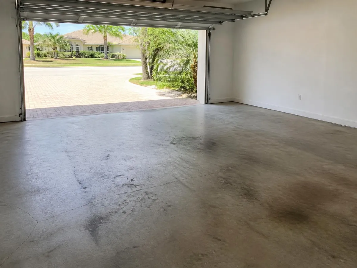 Stained bare concrete garage floor before epoxy coating in Rockledge, FL