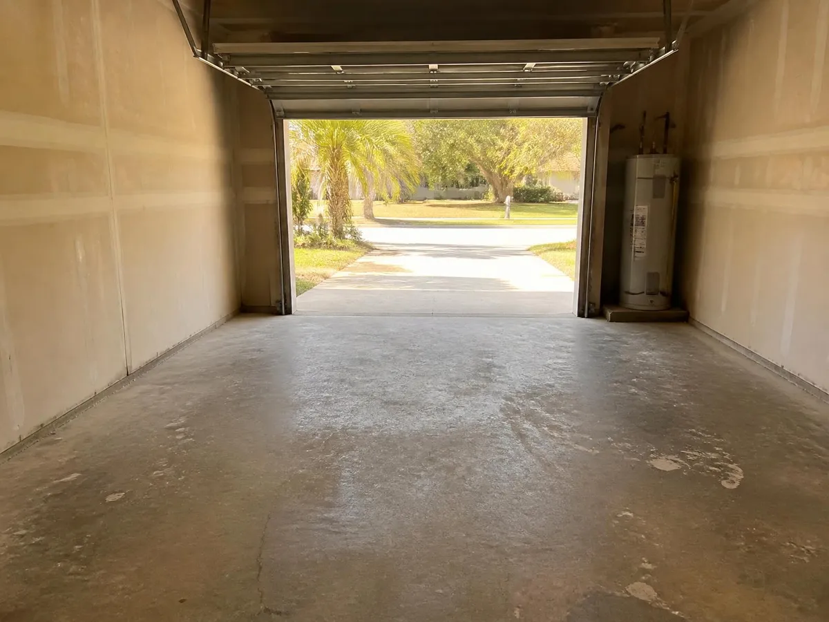 Dull unsealed concrete garage floor before epoxy in Melbourne, FL