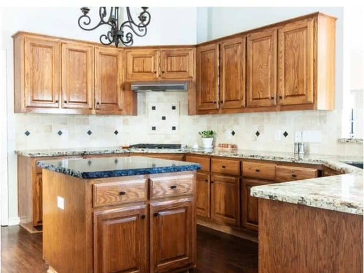 Honey oak kitchen cabinets before refinishing in Melbourne, FL