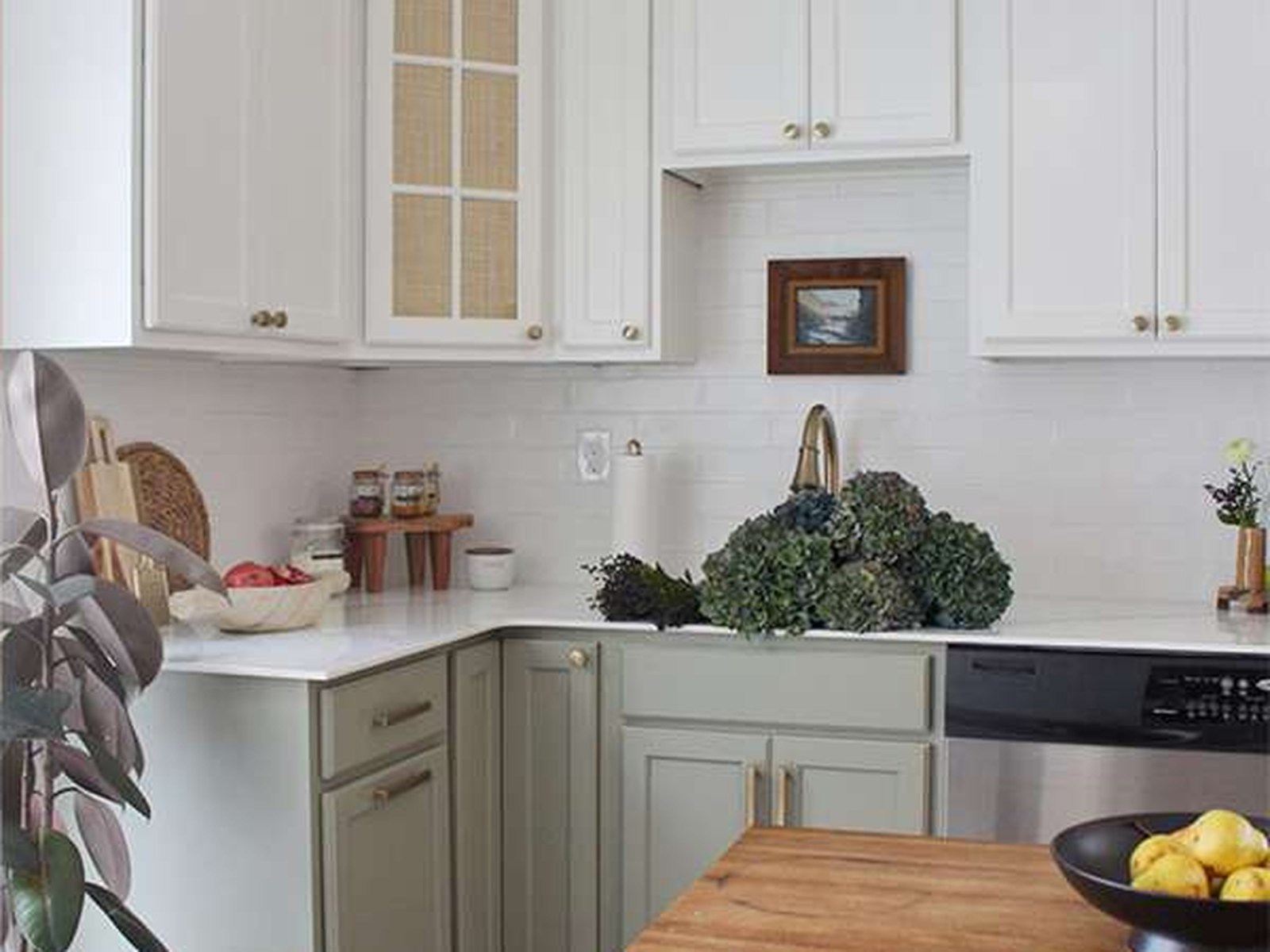 Sage green and white refinished kitchen cabinets in Rockledge, FL
