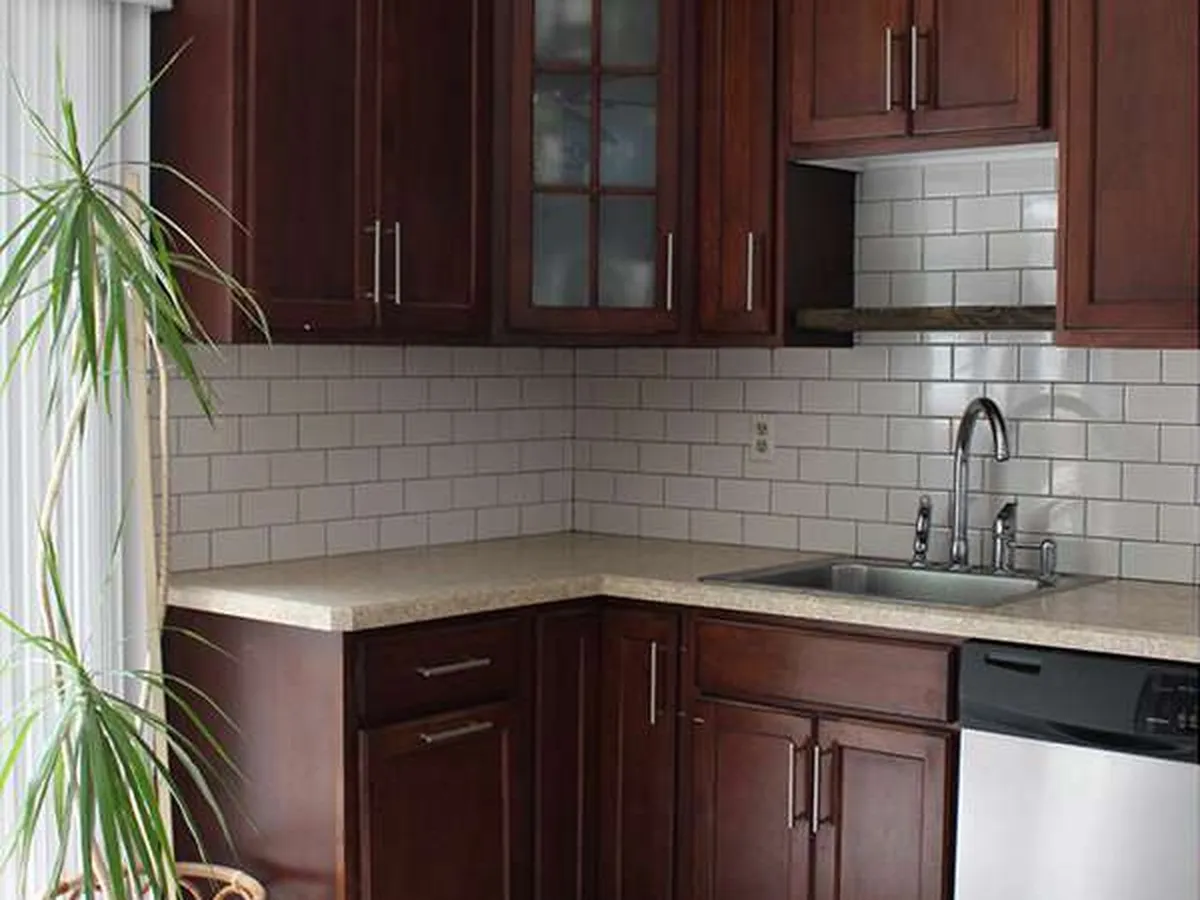 Dated wood kitchen cabinets before refinishing in Rockledge, FL