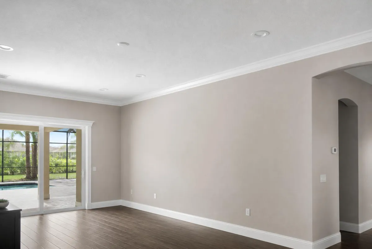 Repaired and repainted living room with smooth white ceiling and warm greige walls in Melbourne Beach, FL