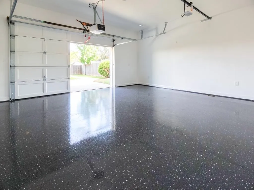 Finished charcoal and white flake epoxy garage floor in a clean two-car garage in Palm Shores, FL
