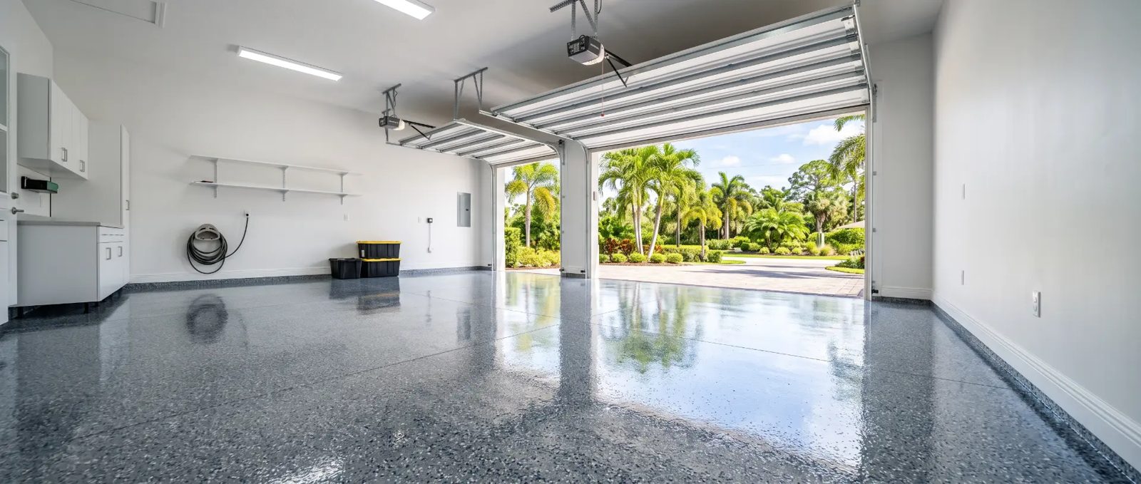 Finished gray-blue flake epoxy garage floor in a three-car garage in Cape Canaveral, FL