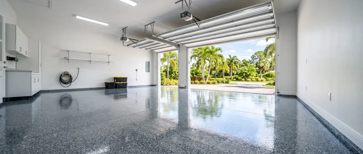 Finished gray-blue flake epoxy garage floor in a three-car garage in Cape Canaveral, FL
