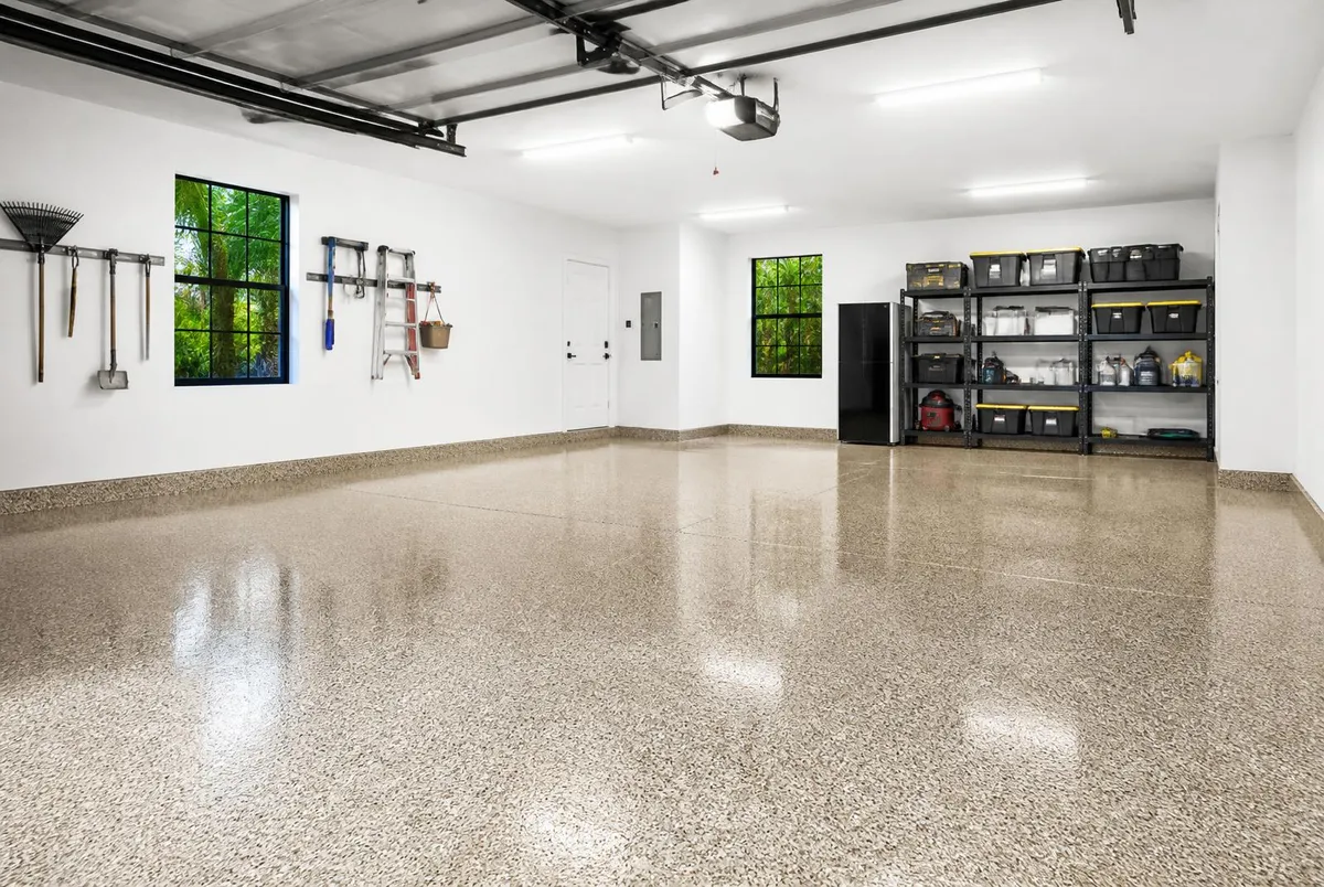 Finished tan and beige flake epoxy garage floor with coved base in a two-car garage in Viera, FL