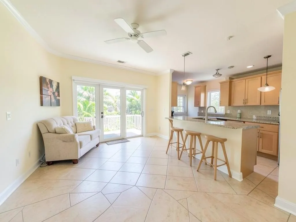 Finished open-concept living room and kitchen painted warm white with bright white ceiling and trim in Grant-Valkaria, FL